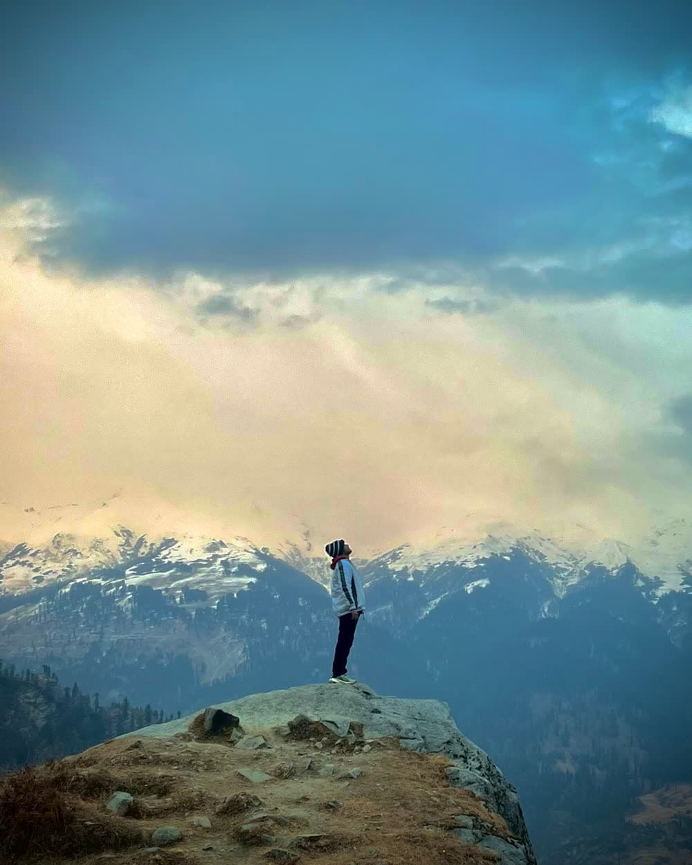 Tirth Raval on a ridge above a forested valley